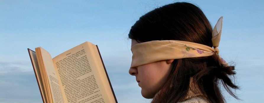 blindfolded girl reading book
